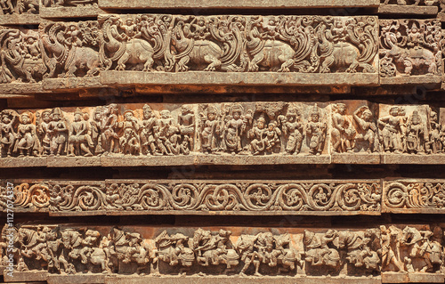 Facade of abandoned Indian temple with carved animals and patterns, India