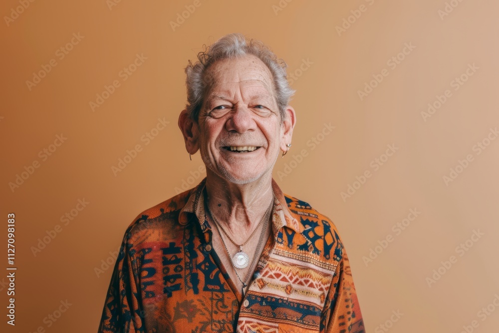 Portrait of a smiling caucasian man in his 80s donning a trendy cropped top over soft orange background Portrait of a smiling caucasian man in his 80s donning a trendy cropped top over soft orange background