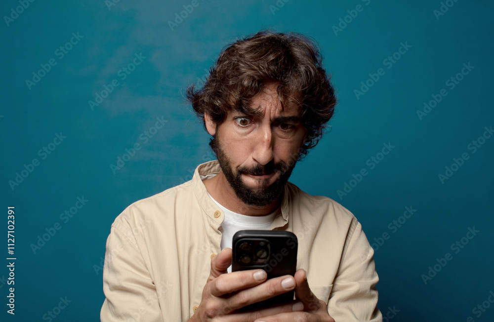 young adult bearded man with a smartphone young adult bearded man with a smartphone