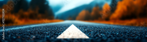 Asphalt road arrow guiding travelers through scenic autumn pavement mountainous region capturing the beauty of nature's pathway