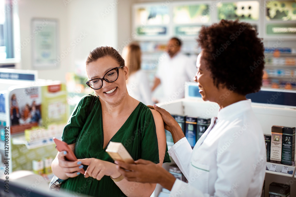 Female pharmacist helping pregnant woman in drug store Female pharmacist helping pregnant woman in drug store