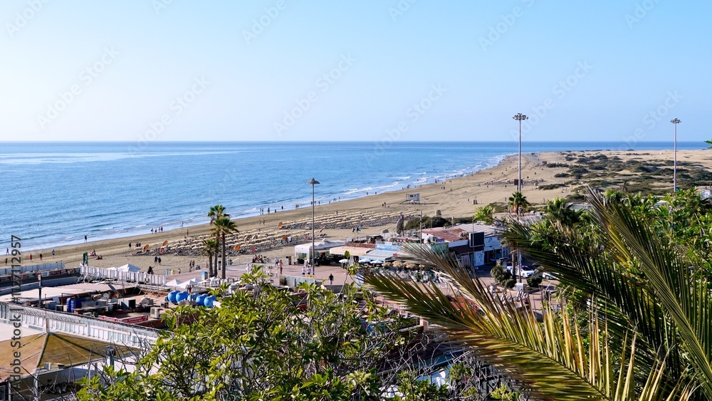 Winter weather in the Canary Islands. Aerial view of Playa del Ingles beach from Las Burras to Punta de Maspalomas. Ocean and dunes on the horizon Winter weather in the Canary Islands. Aerial view of Playa del Ingles beach from Las Burras to Punta de Maspalomas. Ocean and dunes on the horizon