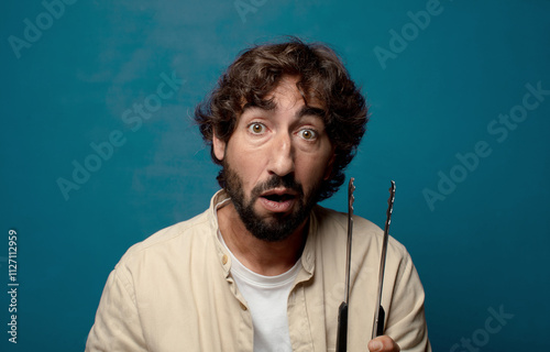 young adult bearded man cooking concept