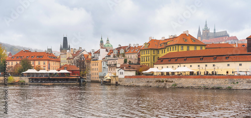 Banks of the Vltava River and view of the hill that houses monuments such as the cathedral of Prague, Czechia.