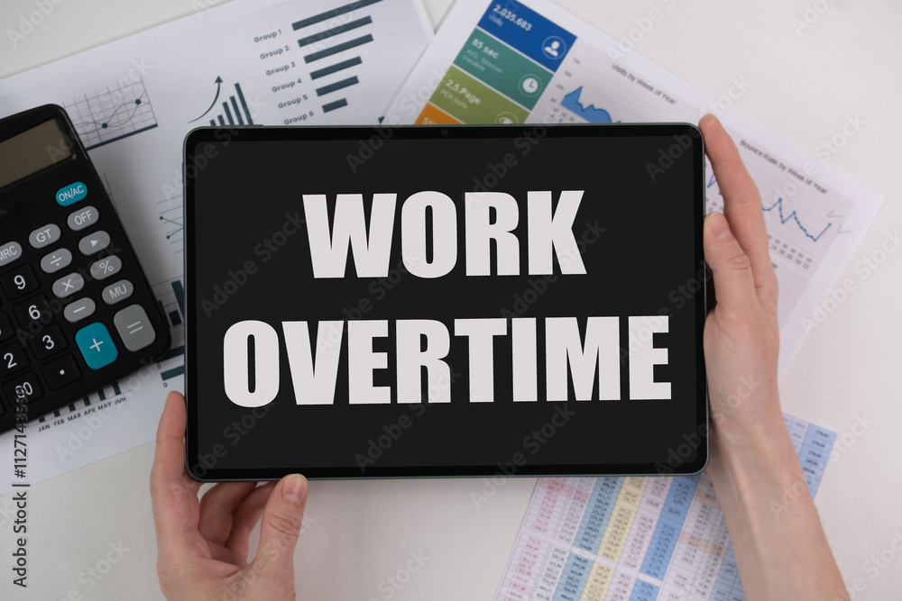 Work overtime, text on a tablet. business concept Work overtime, text on a tablet. business concept