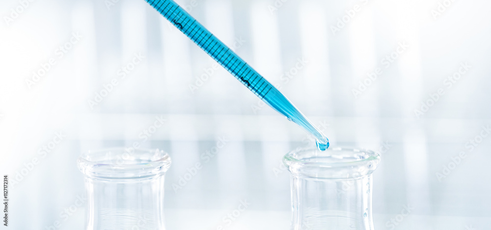 Doctor or scientist using pipette to drop a sample to test tube in medical research lab or science laboratory Doctor or scientist using pipette to drop a sample to test tube in medical research lab or science laboratory