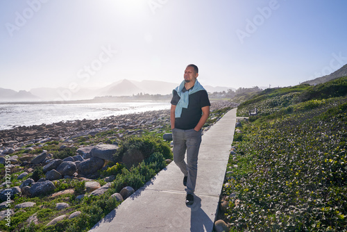 Man walking on footpath in landscape photo