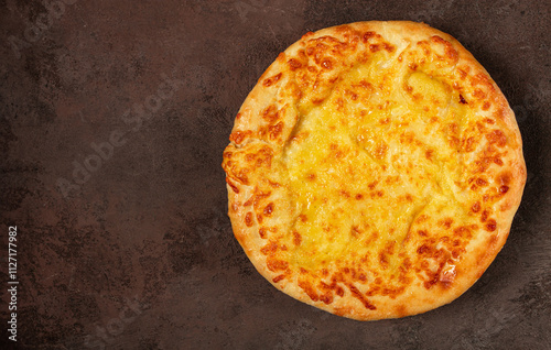 khachapuri in Megrelian, a traditional Georgian dish, flatbread with cheese, top view, no people, photo