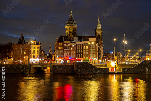 City scenic from Amsterdam by night with the St. Nicolas church in the Netherlands