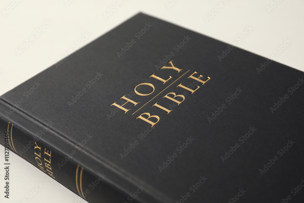 Hardcover Holy Bible on white table, closeup Hardcover Holy Bible on white table, closeup