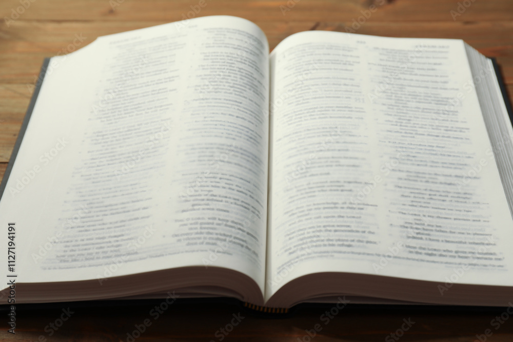 Open Holy Bible in English language on wooden table, closeup Open Holy Bible in English language on wooden table, closeup