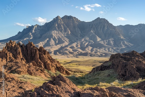 A breathtaking landscape dominated by towering rocky mountains in the background