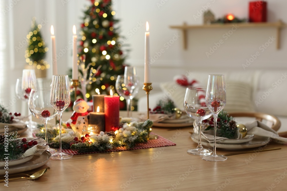 Christmas place setting with festive decor on wooden table in room Christmas place setting with festive decor on wooden table in room