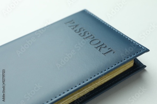 Passport in dark blue cover on light background, closeup