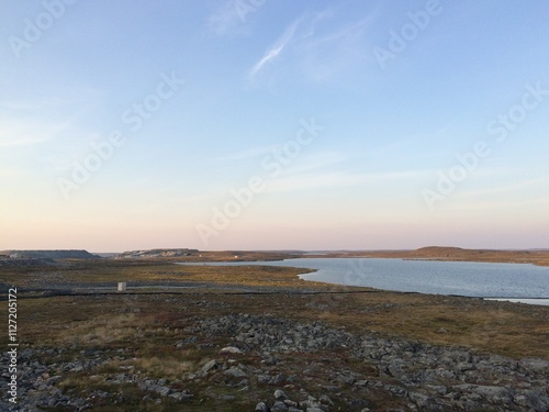 Remote mine site in northern Canada with a small lake and blue skies, near Meadowbank Mine Site, Nunavut Territory, Canada