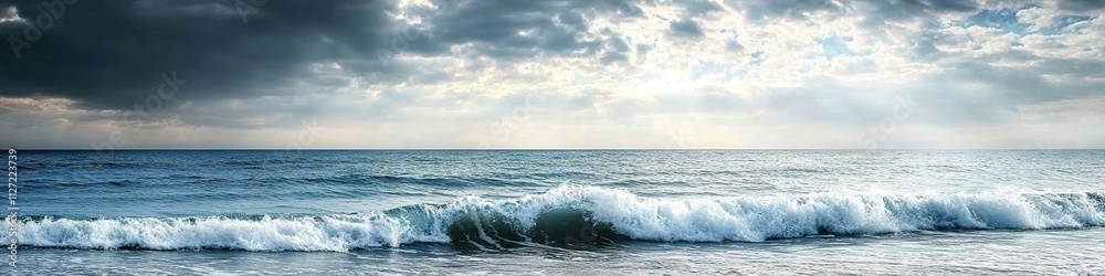 Fototapeta premium Cloudy skies over calm sea waves