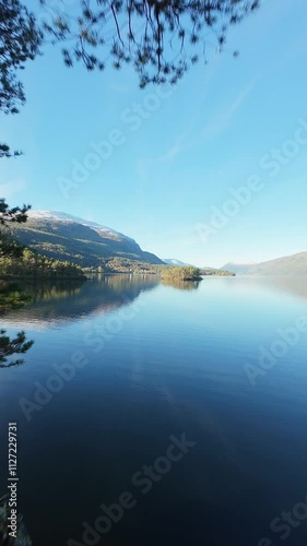 Small island in the center of lake in the mountains of Norway