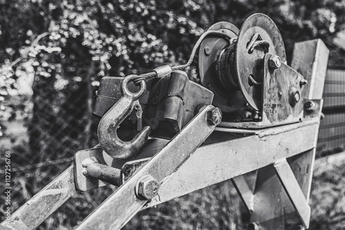 Close-up of a winch with a large, metal hook. Capstan winch for transporting boats.