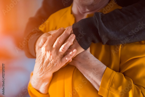 Man support his old grandmother, holds her hands.