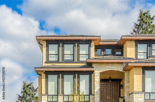Wallpaper Mural Top of grey stucco luxury house with shingle roof, red and yellow trees and nice windows in Summer in Vancouver, Canada, North America. Day time on June 2024. Torontodigital.ca