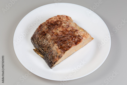 Piece of stuffed fish carp on a white dish photo