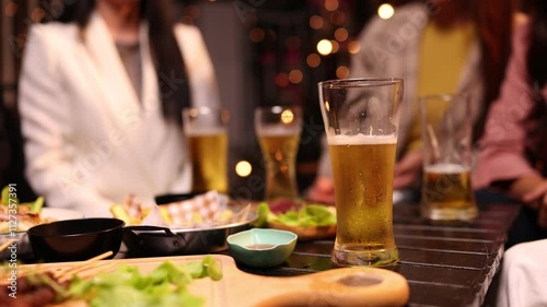 Group of friends clinking glasses in celebration at night, Happy group of friends having celebration and drinking dinner party at night, Holiday, Festival celebration.