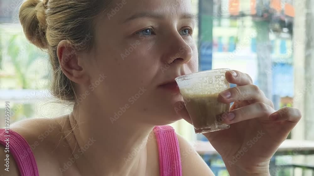 A woman is relishing a delightful meal and drinks in a modern cafe A woman is relishing a delightful meal and drinks in a modern cafe