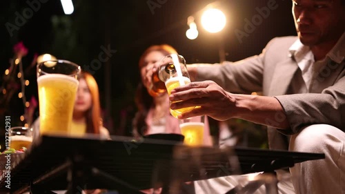 Group of friends clinking glasses in celebration at night, Happy group of friends having celebration and drinking dinner party at night, Holiday, Festival celebration.