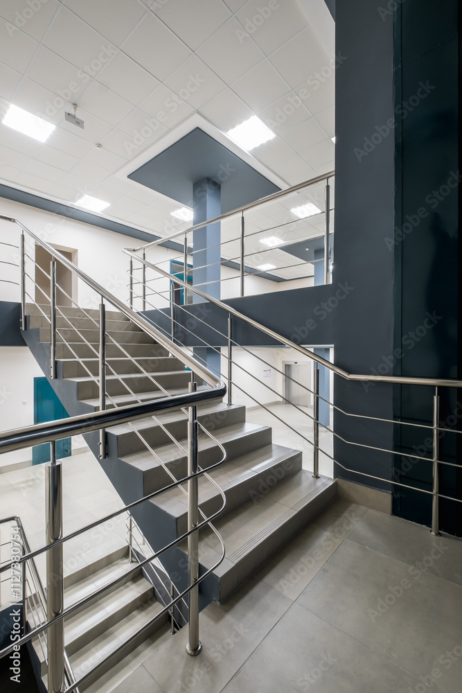 Fototapeta premium stairs emergency and evacuation exit stair in up ladder in a new office building at night