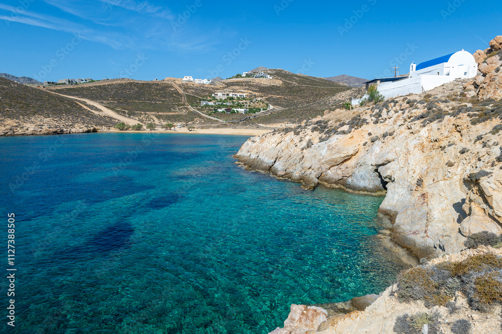 Obraz premium View of rustic Agios Sostis church perched on the rocky cliffs above a beach with the same name on the Greek island of Serifos.