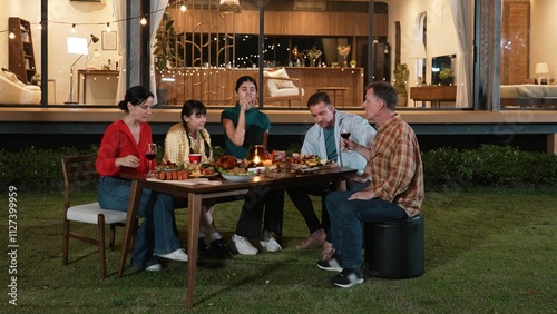 Family gather celebrate holiday. Parents, grandparents and girl together to talk and have dinner party food. Outdoor activity for spending time with multigeneration cross generation gap. Divergence. photo