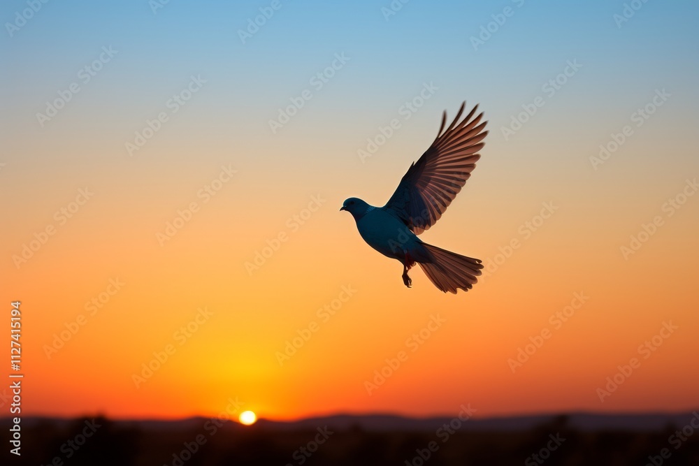 Fototapeta premium Silhouette of a bird in flight against blue hues symbolizing freedom and aspirations