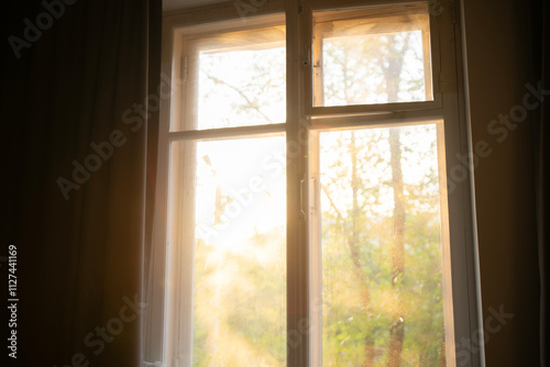 Warm sunlight floods into the room through the window, creating a bright and inviting atmosphere in the early morning