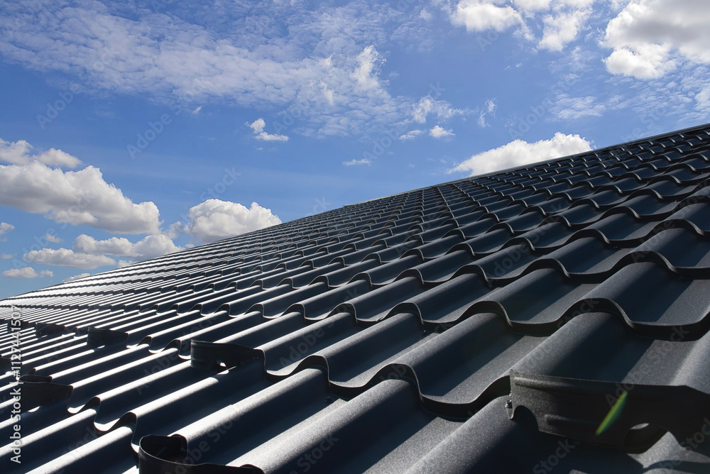Naklejka premium Metal roof tile with sky home building construction
