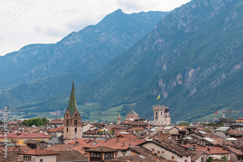 Scenic view of old town of Trento seen from Loggia Veneziana in castle Museo Castello del Buonconsiglio, Trentino Alto Adige, Italy. Surrounded by majestic Dolomites mountains. Cityscape in summer photo