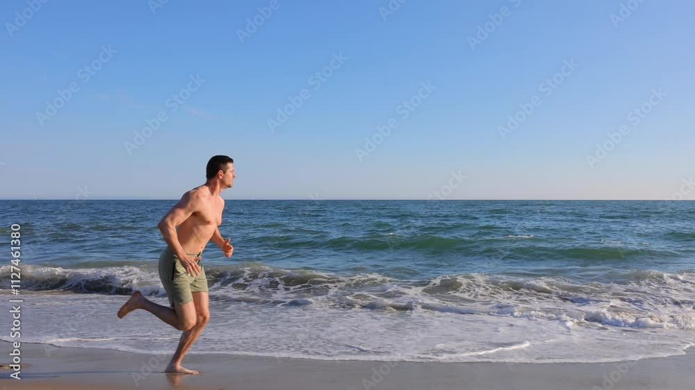 Athletic man jogging at the beach in Southern California. Slow Motion. Athletic man jogging at the beach in Southern California. Slow Motion.