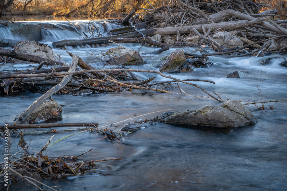Obraz premium water diverssion dam on the Poudre River in Fort Collins, Colorado, late fall scenry