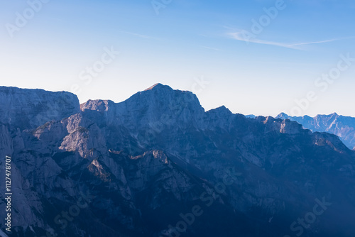 Panoramic view of rugged mountain peak Monte Cimone seen from top of Piper. Majestic ridges of Julian Alps in Dogna valley, Friuli Venezia Giulia, Italy. Wanderlust in Italian Alps in summer. Awe photo