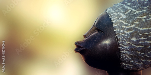 Black statue of a woman. Silhouette of an African woman's face. African wood figure from South Africa.
