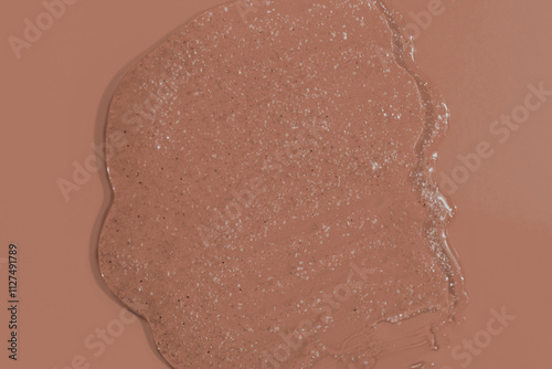 Demonstrating color of the year 2025. Mocha mousse color swatch. Cosmetic serum or scrub swatch on brown sepia background.