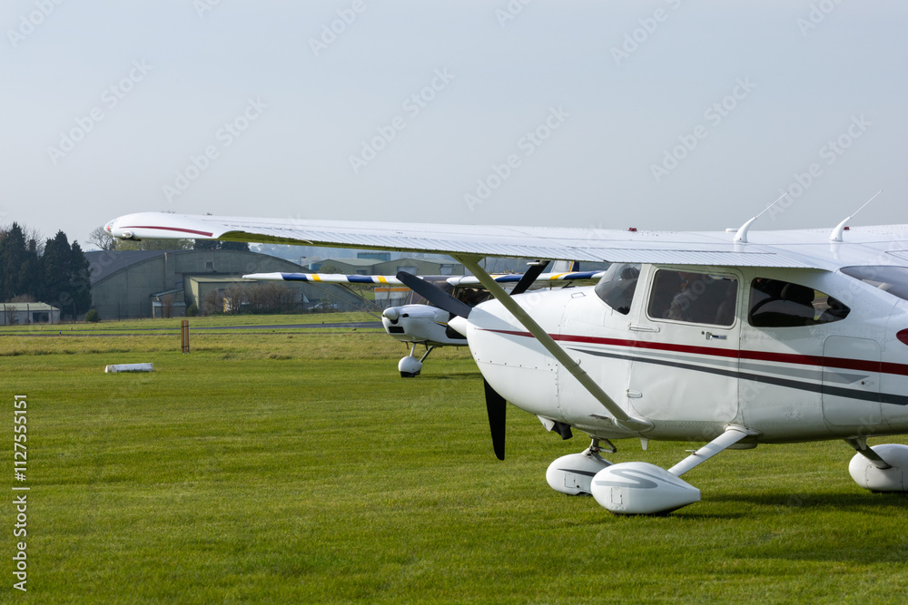 Pair of high wing monoplanes on a grass airfield. Pair of high wing monoplanes on a grass airfield.