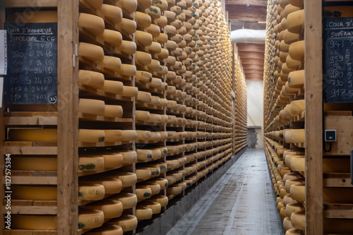 Aging rooms with shelves in cheese caves, central location for aging of wheels, rounds of Comte cheese from four months to several years made from raw cow milk, Jura, France photo