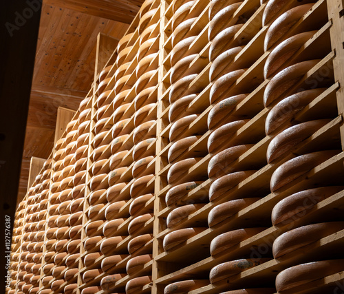 Aging rooms with shelves in cheese caves, central location for aging of wheels, rounds of Comte cheese from four months to several years made from raw cow milk, Jura, France photo