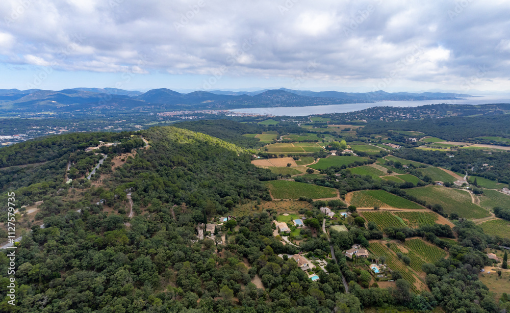 Aerial view on green hills, houses, gulf of saint-tropez, Gassin village, vineyards, Provence, Var, France Aerial view on green hills, houses, gulf of saint-tropez, Gassin village, vineyards, Provence, Var, France