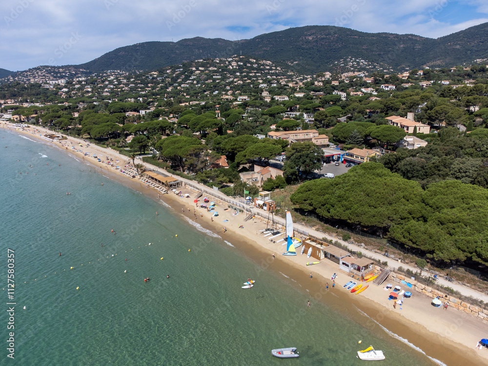 Aerial view on boats, crystal clear blue water of Plage du Debarquement white sandy beach near Cavalaire-sur-Mer and La Croix-Valmer, summer vacation on French Riviera, Var, France Aerial view on boats, crystal clear blue water of Plage du Debarquement white sandy beach near Cavalaire-sur-Mer and La Croix-Valmer, summer vacation on French Riviera, Var, France