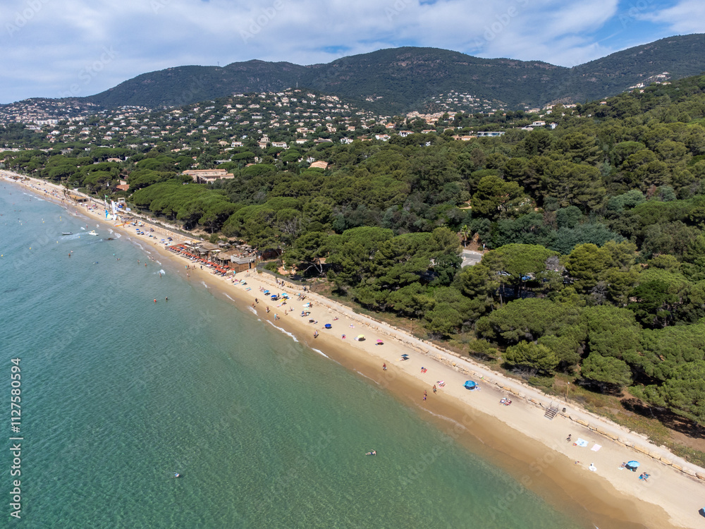 Aerial view on boats, crystal clear blue water of Plage du Debarquement white sandy beach near Cavalaire-sur-Mer and La Croix-Valmer, summer vacation on French Riviera, Var, France Aerial view on boats, crystal clear blue water of Plage du Debarquement white sandy beach near Cavalaire-sur-Mer and La Croix-Valmer, summer vacation on French Riviera, Var, France