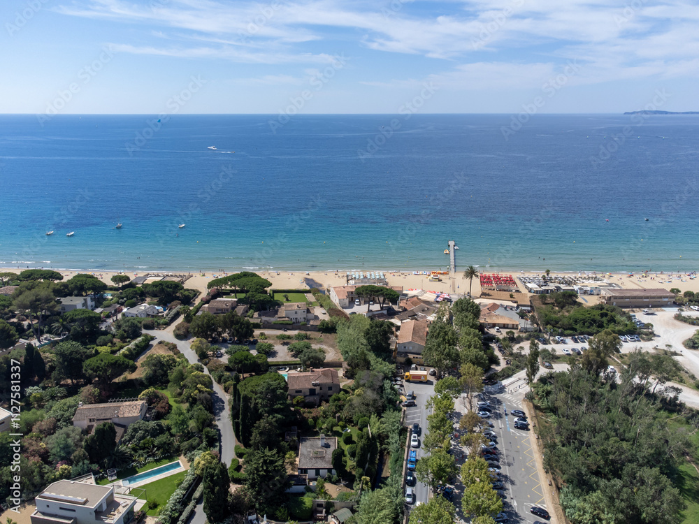 Fototapeta premium Aerial view on boats, crystal clear blue water of Plage du Debarquement white sandy beach near Cavalaire-sur-Mer and La Croix-Valmer, summer vacation on French Riviera, Var, France
