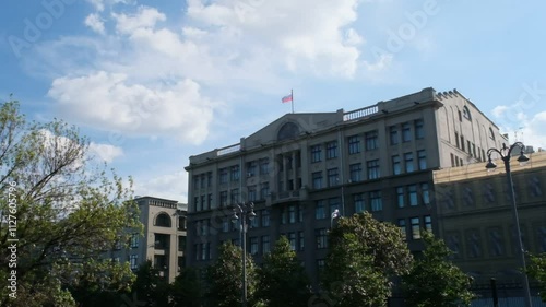 Moscow, Russia - Aug 16 2024: A slow-motion video of a government building in Moscow with the Russian flag waving atop the roof, under a bright blue sky
