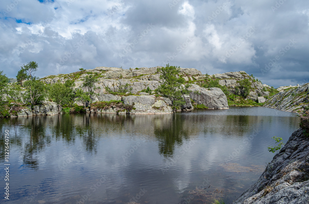 Mountain lake on the route to Preikestolen (The Pulpit Rock), a tourist attraction in Rogaland county, Norway Mountain lake on the route to Preikestolen (The Pulpit Rock), a tourist attraction in Rogaland county, Norway