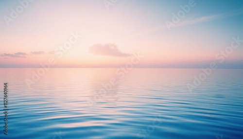 view of a calm ocean with a sunset in the background